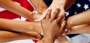 Hands together over American flag
