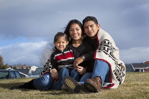 Photo of Native family wrapped in a blanket