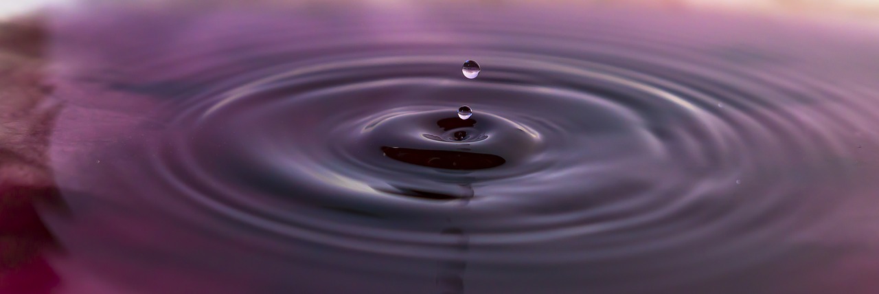 Drop of water on water with ripple