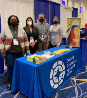 Group standing at ORN booth during CADCA