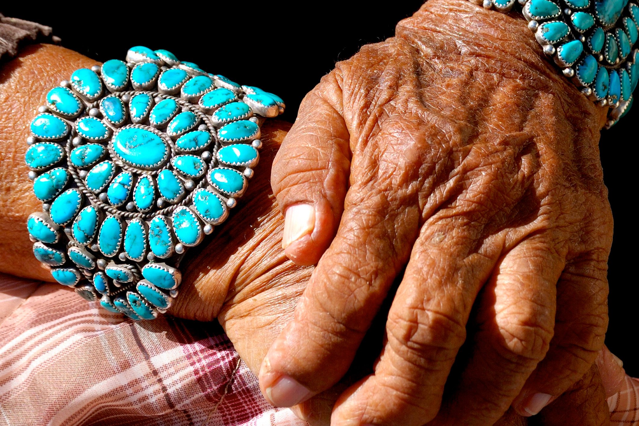 old hands wearing turquoise